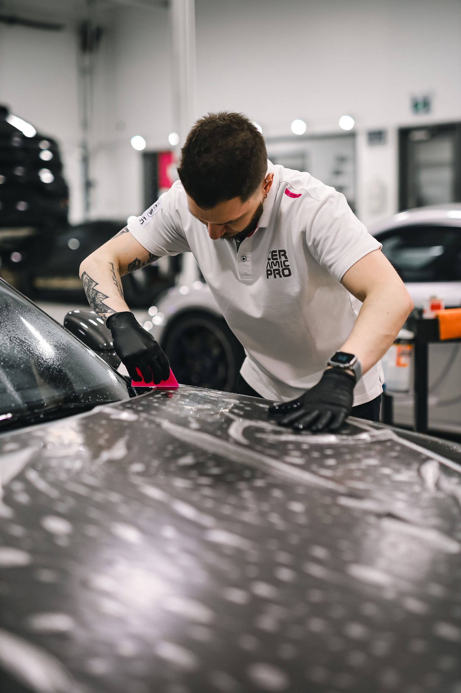 Technician applying ceramic coating to a vehicle