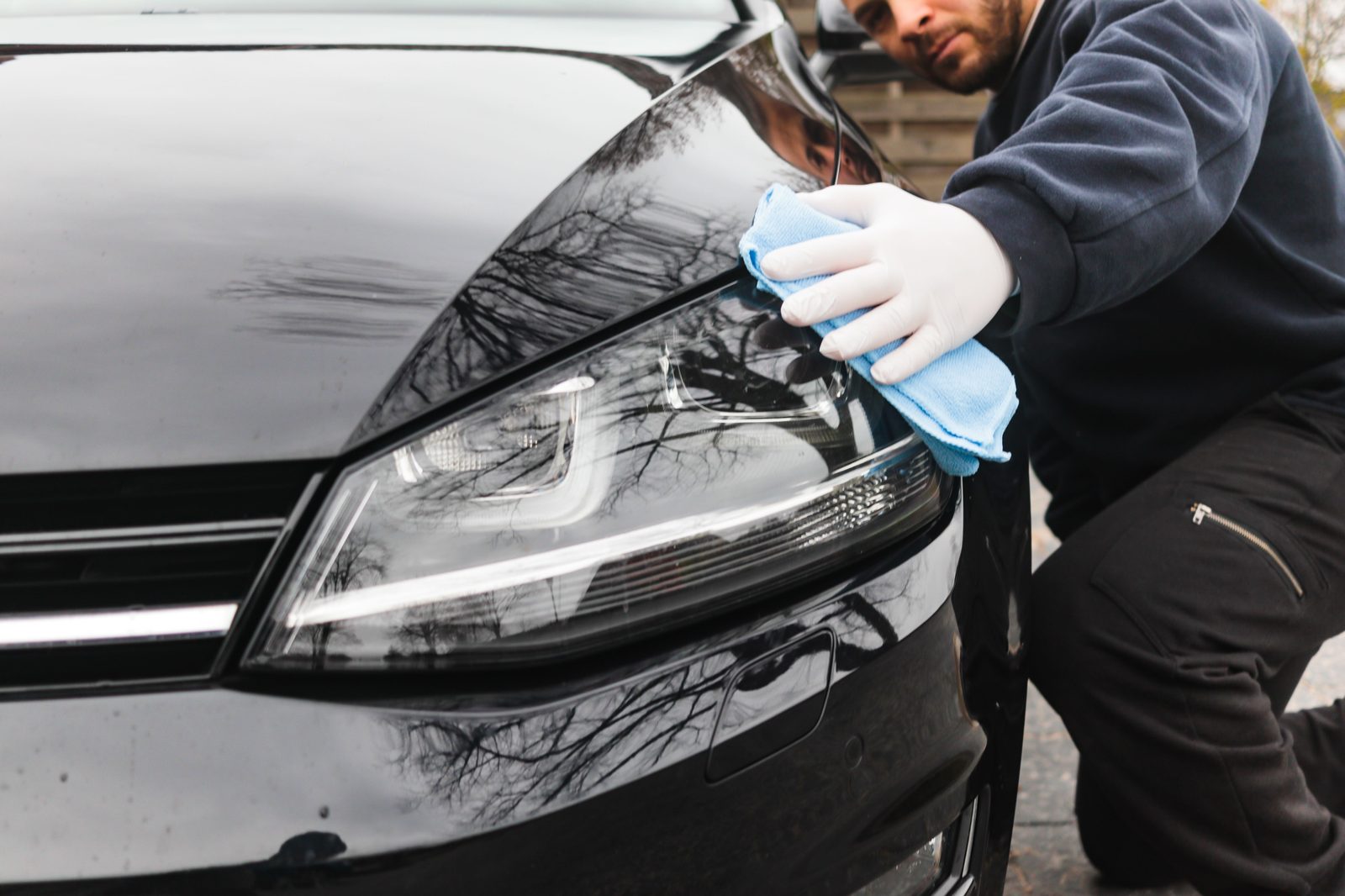 Technician detailing a vehicle