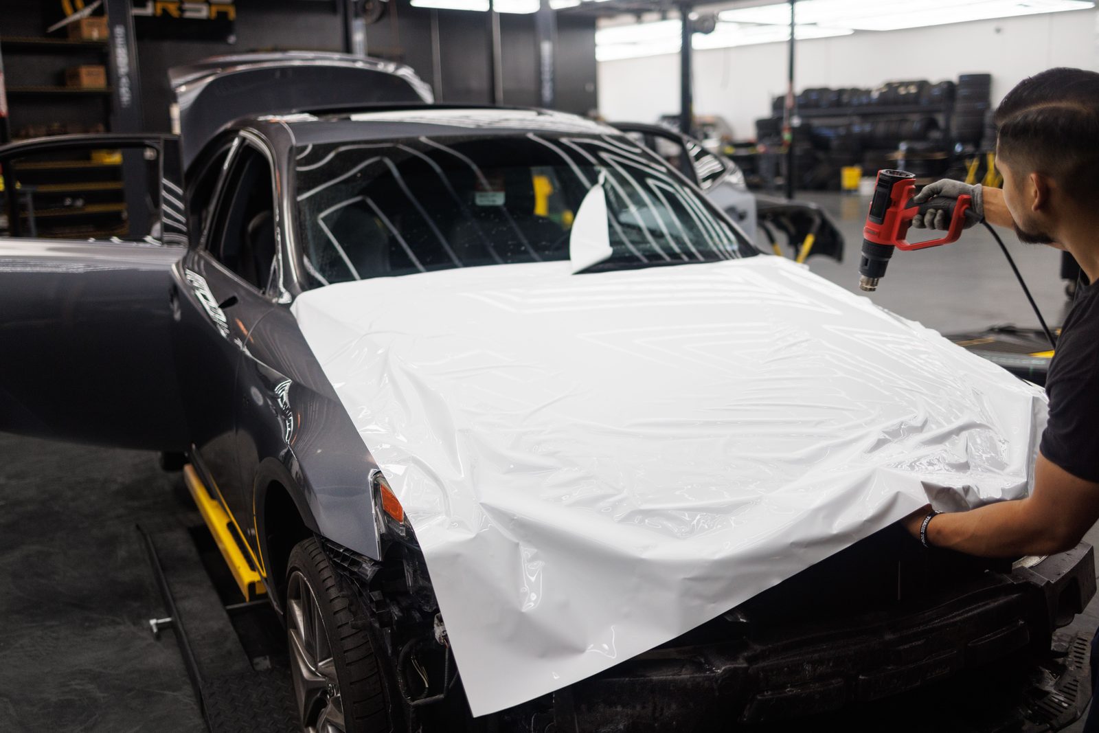 Technician working on a vehicle in the JD Auto shop